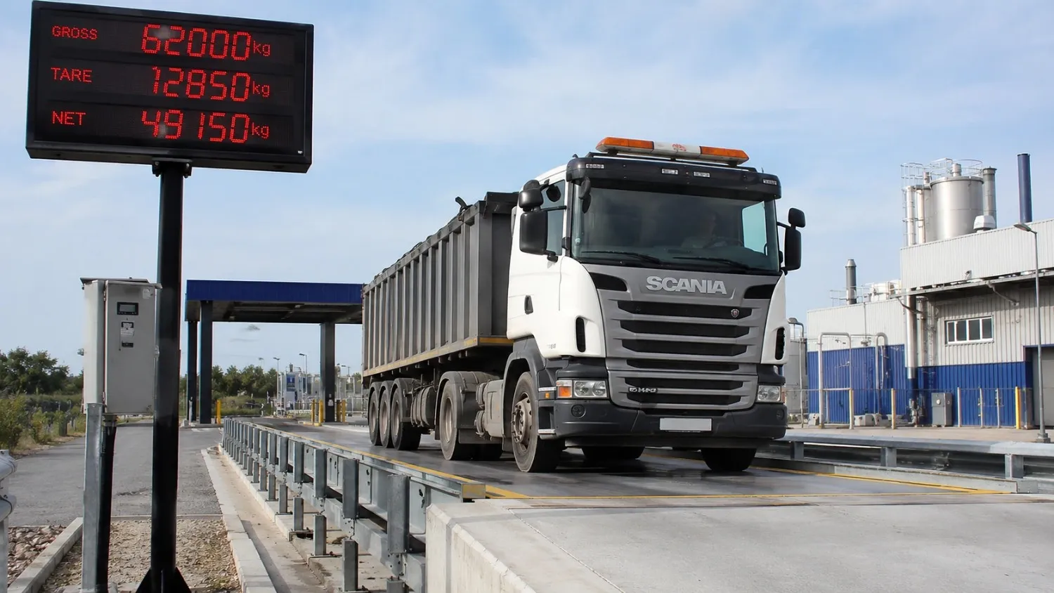 Truck on digital weighbridge system at industrial site